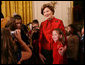 Mrs. Laura Bush poses for a photo with a young guest following the performance of the Ford's Theater cast members presentation of “A Christmas Carol,” Monday, Dec. 3, 2007, at the White House Children’s Holiday Reception. White House photo by Shealah Craighead