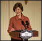 Mrs. Laura Bush speaks to the audience Monday, Jan. 28, 2008, during the President's Committee on the Arts and the Humanities Coming Up Taller awards ceremony in the East Room of the White House. Mrs. Bush told her audience, "The Coming Up Taller award winners have made a demonstrable impact on the lives of children, many of whom need extra attention from caring adults to help them stay on track for a healthy and successful life." White House photo by Shealah Craighead