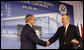 President George W. Bush is welcomed to the podium after an introduction by former President George H.W. Bush Friday, Aug. 8, 2008, at the dedication for the U.S. Embassy in Beijing. White House photo by Eric Draper