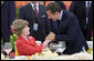 Mrs. Laura Bush is greeted by France President Nicolas Sarkozy during a social luncheon Friday, Aug. 8, 2008, at the Great Hall of the People in Beijing in honor of the 2008 Summer Olympic Games. White House photo by Eric Draper