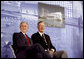 President George W. Bush and former President George H.W. Bush sit on stage at the U.S. Embassy in Beijing Friday, Aug. 8, 2008, during dedication ceremonies. Both are scheduled to attend opening ceremonies scheduled for later in the evening. White House photo by Eric Draper