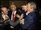 President George W. Bush is hugged by a young boy Friday, Aug. 8, 2008, during a greeting at the U.S. Embassy in Beijing. White House photo by Eric Draper