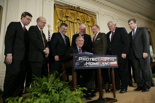 President George W. Bush is joined by House and Senate representatives as he signs H.R. 3199, USA Patriot Improvement and Reauthorization Act of 2005, Thursday, March 9, 2006 in the East Room of the White House. From left to right are U.S. Sen. Jim Talent, R-Mo.; U.S. Sen. Pat Roberts, R-Kan.; U.S. Rep. Peter King, R-NY; U.S. Rep. Jim Sensenbrenner, R-Wis.; U.S. Sen. Arlen Specter, R-Pa.; House Speaker Dennis Hastert, R-Ill., and Majority Whip U.S. Rep. Roy Blunt, R- Mo. White House photo by Eric Draper