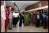 President George W. Bush, Mrs. Laura Bush, and to the President's right, Ugandan President Yoweri Museveni and Mrs. Museveni sing along with a choir and staff members of The AIDS Support Organization (TASO) Centre in Entebbe, Uganda Friday, July 11, 2003.