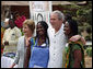 President George W. Bush and Mrs. Laura Bush pose for a photo with two women Wednesday, Feb. 20, 2008, during his visit to the International Trade Fair Center in Accra, Ghana. White House photo by Eric Draper