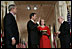 President George W. Bush watches Thursday, Sept. 29, 2005 in the East Room of the White House in Washington, as Judge John G. Roberts is sworn-in as the 17th Chief Justice of the United States by Associate Supreme Court Justice John Paul Stevens. Judge Roberts' wife Jane is seen holding the Bible.