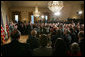 President George W. Bush, left, listens as newly confirmed U.S. Supreme Court Justice Samuel Alito addresses an audience, Tuesday, Feb. 1, 2006 in the East Room of the White House, prior to being sworn-in by U.S. Supreme Court Chief Justice John Roberts. White House photo by Paul Morse