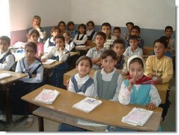 Iraqi primary school children enjoy a new day of education in their newly rehabilitated class room.