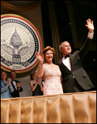 President George W. Bush and Laura Bush greet the audience during the Texas State Society's Black Tie and Boots Inaugural Ball in Washington, D.C., Jan. 19, 2005. White House photo by Eric Draper.