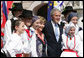 President George W. Bush and Laura Bush pose for a photo with children dressed in traditional outfits during their visit Tuesday, June 10, 2008, to the Lipizzaner Horse Exhibition at Brdo Castle in Kranj, Slovenia. White House photo by Shealah Craighead