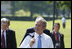 President George W. Bush walks carrying his jacket over his shoulder on his way to a meeting with European Union leaders Tuesday, June 10, 2008 at Brdo Castle in Kranj, Slovenia. 