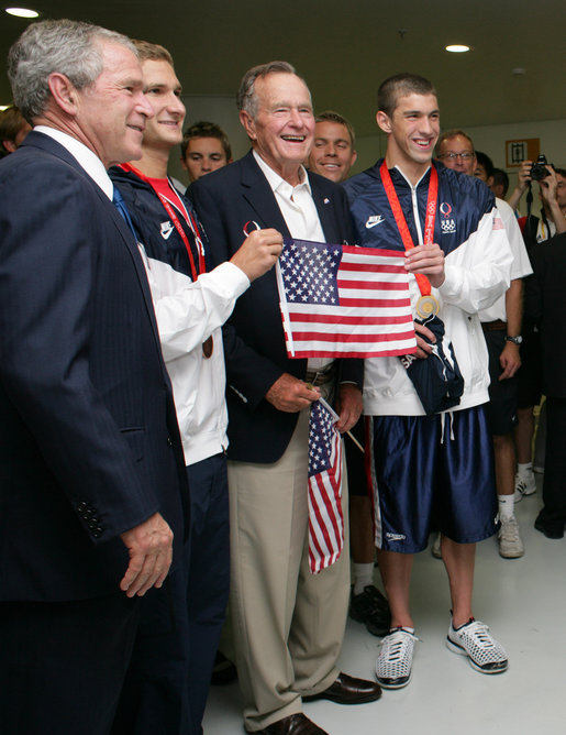 President George W. Bush and former President George H.W. Bush pose for photos with U.S. Olympic swimmers Larsen Jensen, left, and Michael Phelps Sunday, Aug. 10, 2008, at the National Aquatics Center in Beijing. White House photo by Shealah Craighead
