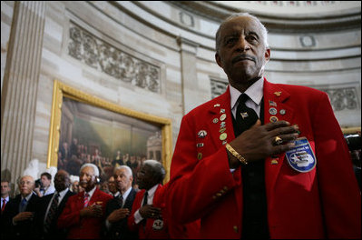 A member of the Tuskegee Airmen stands with his hand over his heart during the National Anthem Thursday, March 29, 2007, at the U.S. Capitol where he and his fellow airmen were bestowed the Congressional Gold Medal, the highest civilian award bestowed by the United States Congress. White House photo by Eric Draper 