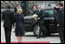 President George W. Bush carries a bouquet of flowers on his arrival to meet President Viktor Yushchenko of Ukraine, and his wife, Mrs. Kateryna Yushchenko Tuesday, April 1, 2008, at the Presidential Secretariat in Kyiv for their welcoming ceremony.