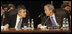 President George W. Bush and Prime Minister Gordon Brown of the United Kingdom, speak together at the start of the day's session Thursday, April 3, 2008, at the 2008 NATO Summit in Bucharest.