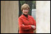 Mrs. Laura Bush peers through an archway at the Dimitrie Gusti Village in Bucharest Thursday, April 3, 2008, as she joined fellow spouses of NATO leaders for a tour of the open-air museum.