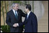 Prime Minister Yasuo Fukuda of Japan greets President George W. Bush as he arrives Monday, July 7, 2008, for the official G8 family photo in the grand lobby of the Windsor Hotel Toya Resort and Spa in Toyako, Japan.