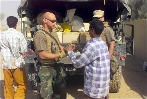 Marines offload food supplies for the humanitarian relief of the Iraqi people.