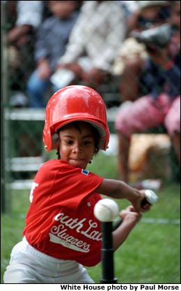 A player swings during the game. White House photo by Paul Morse