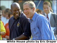 President George W. Bush and Dallas Cowboy Emmitt Smith take in the excitement of the White House Fitness Expo on the South Lawn.