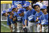 Players of the Jose M. Rodriguez Little League Angels of Manatí, Puerto Rico, all look over toward President George W. Bush as he welcomes everyone to the 2008 Tee Ball on the South Lawn Season Opener Monday, June 30, 2008, on the South Lawn of the White House.