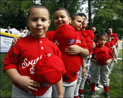 Players of the Cramer Hill Little League Red Sox of Camden, New Jersey hold their hats over their hearts during the singing of the National Anthem at the 2008 Tee Ball on the South Lawn Season Opener Monday, June 30, 2008, on the South Lawn of the White House.