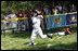  Five-year-old Alex Thaler of the Eastern U.S. All-Stars makes a valiant effort as Jackson McGough of the Central U.S. All-Stars crosses the plate Wednesday, July 16, 2008, during All-Star Tee Ball at the White House. Players from across the United States gathered for the first time on the White House lawn to play the doubleheader that matched the Southern U.S. against the Western U.S. in the second game.