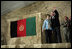 President George W. Bush and Laura Bush wave to an audience of U.S. and Coalition troops, Wednesday, March 1, 2006, upon their arrival to Bagram Air Base in Afghanistan.