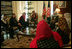 Laura Bush and Dr. Zenat Karzai, wife of President Hamid Karzai, U. S. Secretary of Education Margaret Spellings, second left, and Under Secretary of State for Global Affairs Paul Dobrianski, left, talk with Afghan women about issues of women's rights and education at the presidential residence in Kabul, Afghanistan Wednesday, March 30, 2005. 