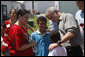 President George W. Bush comforts a family displaced by recent flooding during his visit Thursday, June 19, 2008, to a Red Cross shelter in Iowa City, Iowa. White House photo by Eric Draper