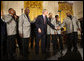 President George W. Bush joins the Temptations on stage in the East Room of the White House Tuesday, Feb. 12, 2008, after they performed during the celebration of African American History Month. White House photo by Eric Draper