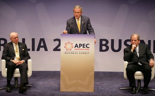 Flanked by Australia's Prime Minister John Howard, left, and Mark Johnson, Chairman of the APEC Business Advisory Council, President George W. Bush delivers remarks Friday, Sept. 7, 2007, to the APEC Business Summit at the Sydney Opera House. President Bush told his audience, "America's commitment to the Asia Pacific region was forged in war and sealed in peace. America is committed to the security of the Asia Pacific region, and that commitment is unshakable." White House photo by Eric Draper