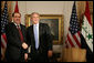 President George W. Bush and Prime Minister Nouri Al-Maliki of Iraq, shake hands after their meeting Tuesday, Sept. 25, 2007, at the Waldorf-Astoria Hotel in New York City. The President told his Iraq counterpart, ".We're with you, Prime Minister. We thank you for the courage of the Iraqi people." White House photo by Eric Draper