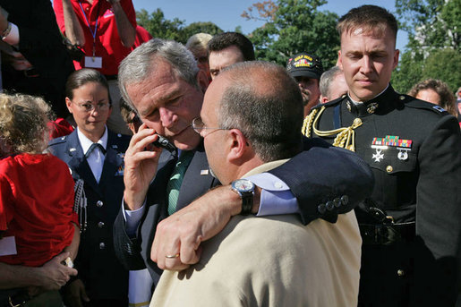 Standing with Jeff Hallal of Indianapolis, President George W. Bush talks with Mr. Hallal’s wife, Pam Hallal, during an event for military support organizations Tuesday, Sept. 18, 2007, on the South Lawn. The Halla's son, Pfc. Deryk Hallal, was killed in action April of 2004 while serving with the U.S. Marines in Iraq. He was posthumously awarded the Bronze Star. White House photo by Eric Draper