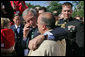 Standing with Jeff Hallal of Indianapolis, President George W. Bush talks with Mr. Hallal’s wife, Pam Hallal, during an event for military support organizations Tuesday, Sept. 18, 2007, on the South Lawn. The Halla's son, Pfc. Deryk Hallal, was killed in action April of 2004 while serving with the U.S. Marines in Iraq. He was posthumously awarded the Bronze Star. White House photo by Eric Draper