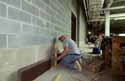 A stone mason checks his measurements on piece of Tennessee Marble basestone