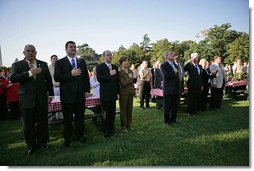 President George W. Bush and Laura Bush stand for the singing of the national anthem during a visit with military support organizations Tuesday, Sept. 18, 2007, on the South Lawn. White House photo by Eric Draper