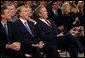 President George W. Bush sits with former Senator Bob Dole, center, and Mayor Stephen Goldsmith and watches the new public service announcement for the USA Freedom Corps in the East Room July 30. 