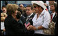 Mrs. Laura Bush speaks with a family member attending the Pentagon Memorial dedication ceremony Thursday, Sept. 11, 2008 at the Pentagon in Arlington, Va., where 184 memorial benches were unveiled honoring all innocent life lost when American Airlines Flight 77 crashed into the Pentagon on Sept. 11, 2001. White House photo by Joyce N. Boghosian