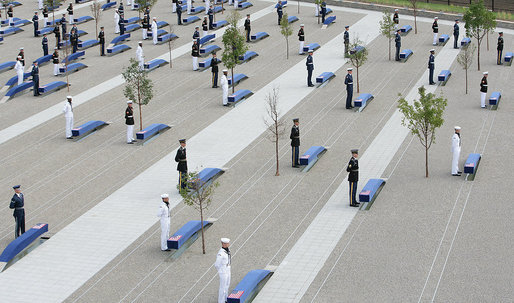 Military personnel stand at attention behind each of the 184 memorial benches draped in ceremonial cloths Thursday, Sept. 11, 2008, during the dedication of the 9/11 Pentagon Memorial at the Pentagon in Arlington, Va. White House photo by Chris Greenberg