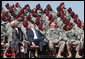 President George W. Bush and U.S. Army Secretary Pete Geren watch members of the U.S. Army's 82nd AIrborne Division parachute onto the field during the President's visit Thursday, May 22, 2008 to Fort Bragg, N.C., for the 82nd Airborne Division Review. White House photo by Chris Greenberg