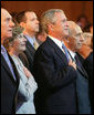 President George W. Bush and Laura Bush are seen with Israeli leaders Prime Minister Ehud Olmert, left, and Israeli President Shimon Peres during the playing of the National Anthem Wednesday, May 14, 2008 in Jerusalem, during a celebration of Israel's 60th anniversary as a nation at the Israeli Presidential Conference 2008 at the Jerusalem International Convention Center. White House photo by Shealah Craighead