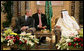 President George W. Bush smiles as he and King Abdullah bin Abdulaziz exchange greetings during a arrival ceremony Friday, May 16, 2008, at the Riyadh-King Khaled International Airport in Riyadh. At center is interpreter Gamal Helal. White House photo by Chris Greenberg