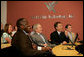 President George W. Bush, seated next to Jim Kavanaugh, right, CEO and co-founder of World Wide Technology, Inc., is shown some of the company's products during a tour of the facility Friday, May 2, 2008, in Maryland Heights, Mo. President Bush also addressed employees and invited guests on the benefit of the stimulus package for the nation's economy. White House photo by Chris Greenberg