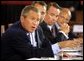 President George W. Bush talks to panelists during a drop-by of the discussion panel on Healthcare Security at the President's Economic Forum held at Baylor University in Waco, Texas on Tuesday August 13, 2002. 