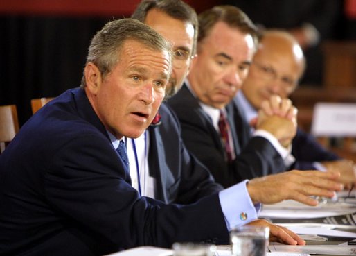 President George W. Bush talks to panelists during a drop-by of the discussion panel on Healthcare Security at the President's Economic Forum held at Baylor University in Waco, Texas on Tuesday August 13, 2002. 