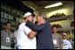 President George W. Bush embraces rescued coal miner John Unger at the Green Tree Fire Department in Green Tree, Pa., Monday, Aug. 5. Pulled from a collapsed mine in Somerset, Pa., nine miners survived three days in a flooded mine shaft before rescuers found them. Also pictured are, from left to right, miners Mark Popernack, Randy Fogle and Tom Foy. White House photo by Paul Morse. White House photo by Paul Morse.