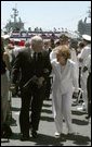 Vice President Dick Cheney talks with former First Lady Nancy Reagan after the commissioning ceremony for the USS Ronald Reagan in Norfolk, Va., July 12, 2003. "As we think this afternoon of our 40th President, we think also of the devoted wife at his side," Vice President Cheney said during the ceremony. "Mrs. Reagan, our nation is so grateful to you. You've shared in your husband's great life. And today, you share in the pride of this tribute from the people of the United States of America."  White House photo by David Bohrer.