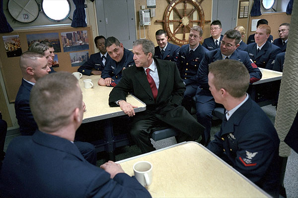 Sitting in the small mess hall decorated with pictures from New York, President George W. Bush takes time to talk during his tour of the United States Coast Guard Cutter Tahoma in Portland, Maine, Jan. 25. White House photo by Eric Draper.