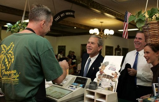 President George W. Bush chats with Ray Cuttle the owner of the La Tropicana Café in Ybor City, Florida on Friday July 16, 2004. White House photo by Paul Morse